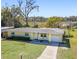 Yellow ranch home with a driveway and a view of a lake at 3710 Sutton Dr, Orlando, FL 32810