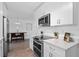 Modern white kitchen with stainless steel appliances at 3710 Sutton Dr, Orlando, FL 32810