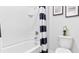 Clean bathroom with shower/tub combo and black and white decor at 3852 Rory Pond Ct, Lakeland, FL 33811