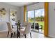 Breakfast nook with glass table and chairs, overlooking backyard at 3852 Rory Pond Ct, Lakeland, FL 33811