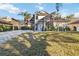 Two-story house with a paved driveway and manicured lawn at 3886 Lake Mirage Blvd, Orlando, FL 32817