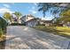 Two-story house with a paved driveway and manicured lawn at 3886 Lake Mirage Blvd, Orlando, FL 32817