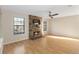 Living room with stone fireplace and hardwood floors at 3886 Lake Mirage Blvd, Orlando, FL 32817