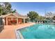 Community pool with lounge chairs, tables, and a shaded area at 3886 Lake Mirage Blvd, Orlando, FL 32817