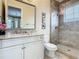 Elegant bathroom with granite countertop and glass shower at 395 Muirfield Loop, Reunion, FL 34747