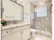 Bright bathroom with a walk-in shower and granite vanity at 395 Muirfield Loop, Reunion, FL 34747