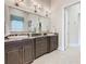 Double vanity bathroom with granite countertop at 395 Muirfield Loop, Reunion, FL 34747