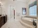 Elegant bathroom with soaking tub and walk-in shower at 395 Muirfield Loop, Reunion, FL 34747