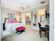 Bedroom with a sitting area and en-suite bathroom at 395 Muirfield Loop, Reunion, FL 34747