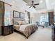 Luxurious main bedroom with sitting area and pool view at 395 Muirfield Loop, Reunion, FL 34747