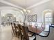 Formal dining room with a large table, chandelier, and decorative wall art at 395 Muirfield Loop, Reunion, FL 34747