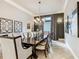 Formal dining room with a large table, chandelier, and dark wood flooring at 395 Muirfield Loop, Reunion, FL 34747