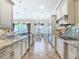 Elegant kitchen boasting granite countertops and custom cabinetry at 395 Muirfield Loop, Reunion, FL 34747