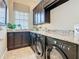 Laundry room with washer, dryer, and granite countertop at 395 Muirfield Loop, Reunion, FL 34747