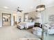 Luxurious main bedroom suite with ensuite bathroom and sitting area at 395 Muirfield Loop, Reunion, FL 34747