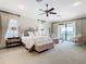 Large main bedroom with sitting area and private balcony access at 395 Muirfield Loop, Reunion, FL 34747