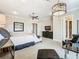 Main bedroom with ample space, featuring a sitting area and TV at 395 Muirfield Loop, Reunion, FL 34747