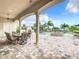 Covered patio with fireplace and outdoor dining area at 395 Muirfield Loop, Reunion, FL 34747