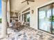 Covered patio with seating area and pool access at 395 Muirfield Loop, Reunion, FL 34747