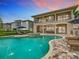 Resort-style pool with patio furniture and a fire pit area at 395 Muirfield Loop, Reunion, FL 34747