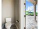 Powder room with view of patio and pool area at 395 Muirfield Loop, Reunion, FL 34747