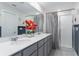 Bathroom featuring double vanity, shower with glass door, and a large framed mirror at 445 N Andrea Cir, Haines City, FL 33844