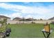 Large grassy backyard with raised garden beds at 4457 Lions Gate Ave, Clermont, FL 34711