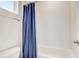 Bathroom with a shower/tub combo and blue shower curtain at 4457 Lions Gate Ave, Clermont, FL 34711