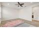 Spacious bedroom with a ceiling fan and en-suite bathroom at 4457 Lions Gate Ave, Clermont, FL 34711