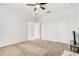 Bright bedroom with neutral wall and carpet, and ceiling fan at 4457 Lions Gate Ave, Clermont, FL 34711