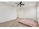 Well-lit bedroom featuring a ceiling fan and plush bedding at 4457 Lions Gate Ave, Clermont, FL 34711