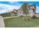 Two-story house on a tree-lined street with a landscaped lawn and paved driveway at 4457 Lions Gate Ave, Clermont, FL 34711