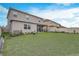 Two-story house with grassy backyard at 4457 Lions Gate Ave, Clermont, FL 34711