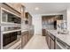 Modern kitchen with dark wood cabinets, granite countertops and stainless steel appliances at 4457 Lions Gate Ave, Clermont, FL 34711