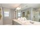 Modern bathroom featuring double sinks, a large mirror, and stylish decor at 4607 Snapdragon Pl, Lake Hamilton, FL 33851