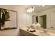 Clean bathroom with double vanity, large mirror and modern decor at 4607 Snapdragon Pl, Lake Hamilton, FL 33851