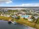 Aerial view showing community pool, lake, and clubhouse at 4731 Clock Tower Dr # 203, Kissimmee, FL 34746