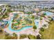 Aerial view of resort-style pool with lazy river, water slide, and mini golf at 4731 Clock Tower Dr # 203, Kissimmee, FL 34746