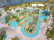 Aerial view of resort-style pool with lazy river, water slide, and mini golf at 4731 Clock Tower Dr # 203, Kissimmee, FL 34746