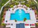 Aerial view of a community pool with surrounding lounge chairs at 4731 Clock Tower Dr # 203, Kissimmee, FL 34746