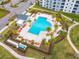 Community pool with plenty of lounge chairs and a cabana at 4731 Clock Tower Dr # 203, Kissimmee, FL 34746