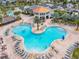 Aerial view of large resort-style pool with surrounding lounge chairs at 4731 Clock Tower Dr # 203, Kissimmee, FL 34746