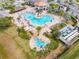 Aerial view of resort-style pool with multiple areas for swimming and relaxing at 4731 Clock Tower Dr # 203, Kissimmee, FL 34746