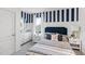 Bright bedroom with navy and white striped walls and comfy bedding at 4823 Cranberry Way, Lakeland, FL 33811