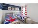 Nautically themed bedroom with twin beds and red and blue bedding at 4823 Cranberry Way, Lakeland, FL 33811