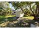 Backyard with shed and large tree providing shade at 501 S Lacy Cir, Deltona, FL 32725