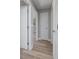 Clean hallway with light wood-look flooring and white doors at 501 S Lacy Cir, Deltona, FL 32725