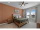 Bedroom with orange accent wall and large window at 5157 Citrus Leaf Blvd, Winter Garden, FL 34787