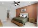 Spacious bedroom with large bed, dresser, and accent wall at 5157 Citrus Leaf Blvd, Winter Garden, FL 34787