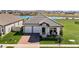 One-story house with two-car garage and lake view in the background at 5157 Citrus Leaf Blvd, Winter Garden, FL 34787